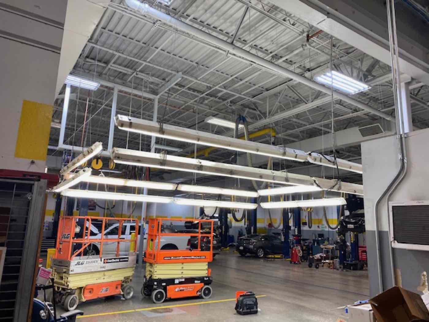 New high-bay lighting installed across a warehouse.