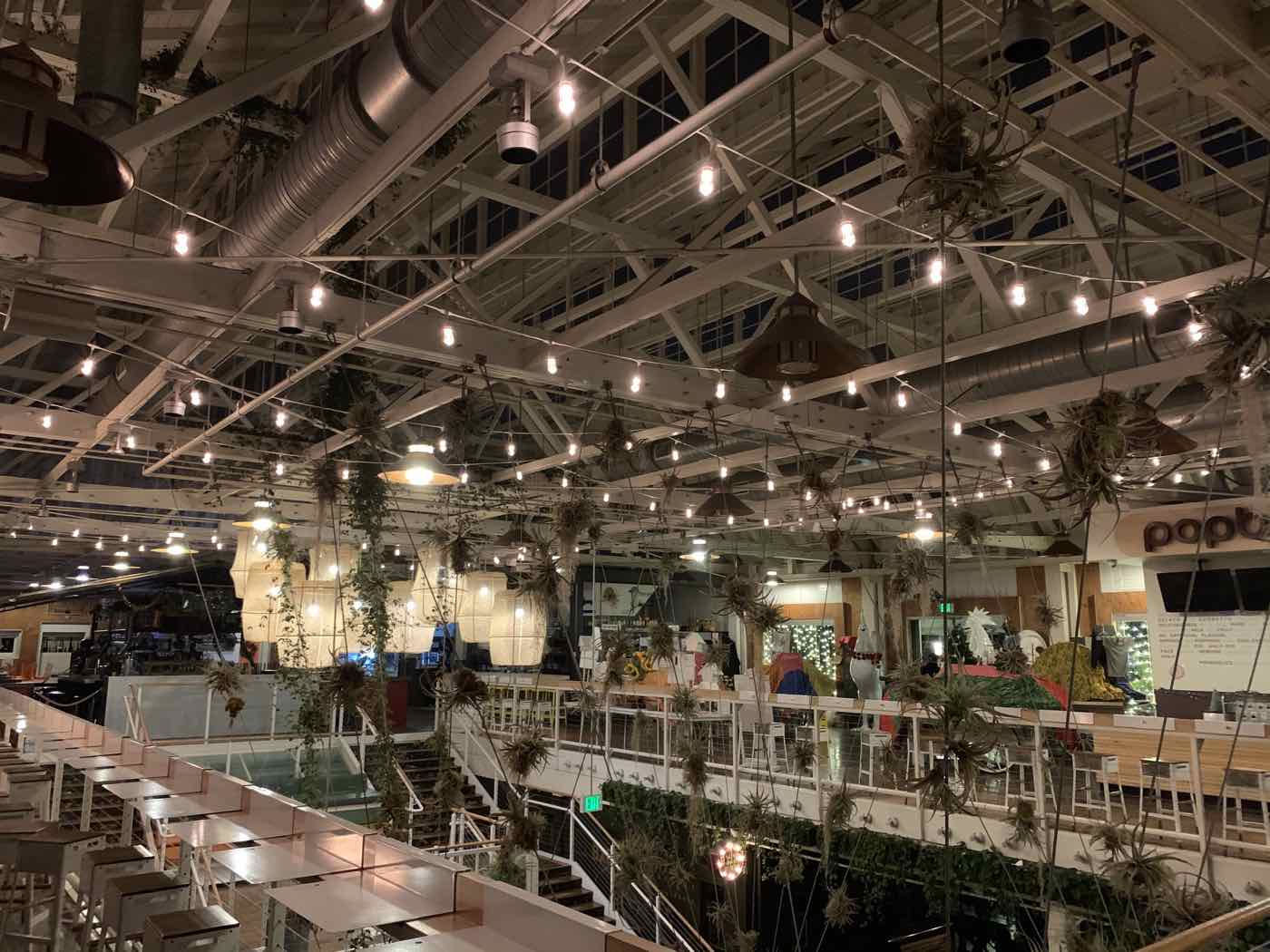 A restaurant patio lit with string lights and fixtures.
