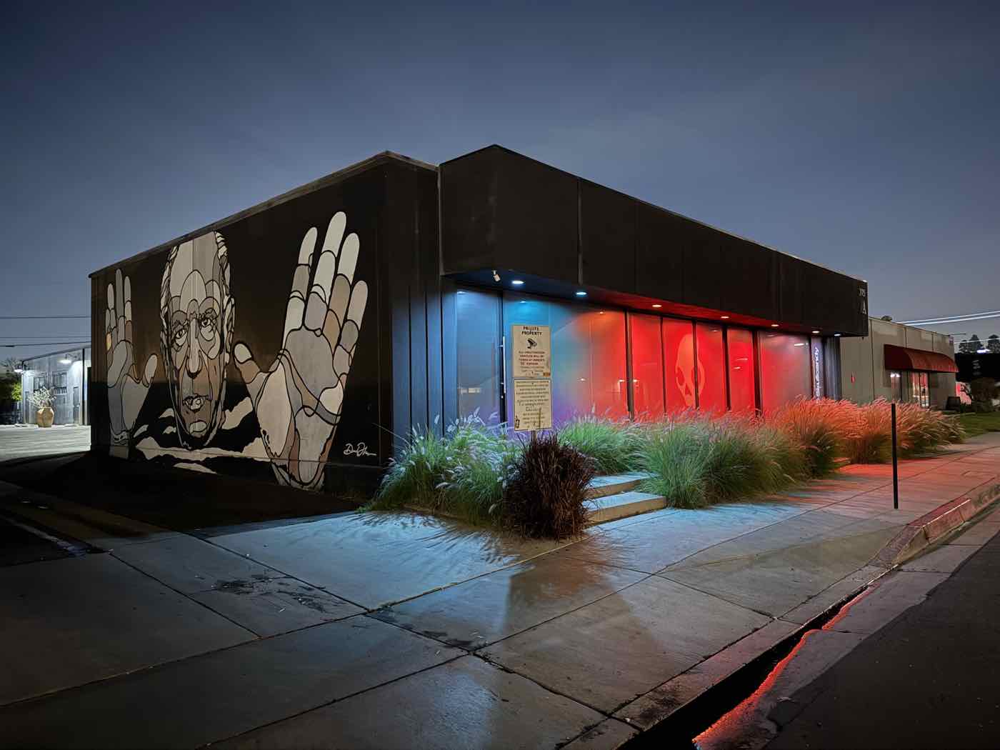A building's exterior lit at night.