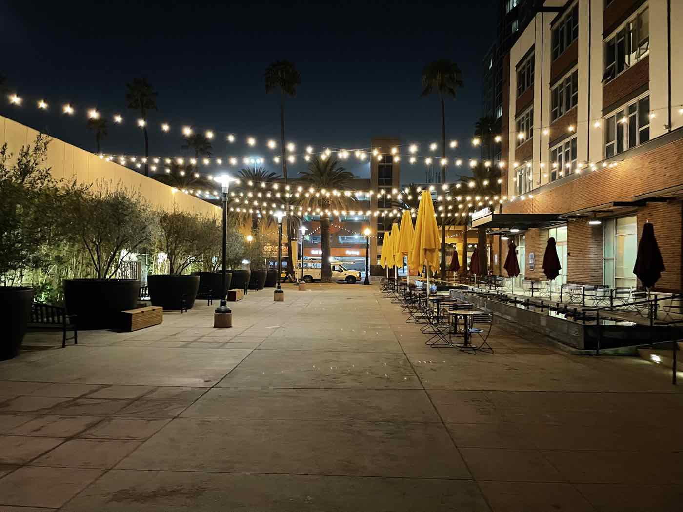 Outdoor dining area with string lights at night.
